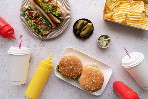 Top view of fast food, hotdogs, chips, burgers and drinks . Top view. Flat lay. - Fotoğraf, Görsel