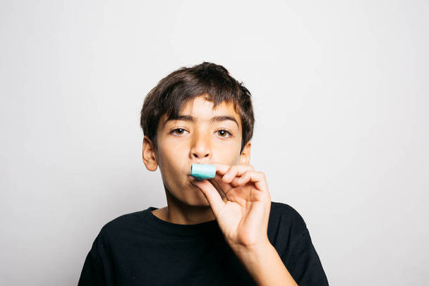 Portret van een tienjarige jongen die confetti in de lucht gooit - Foto, afbeelding