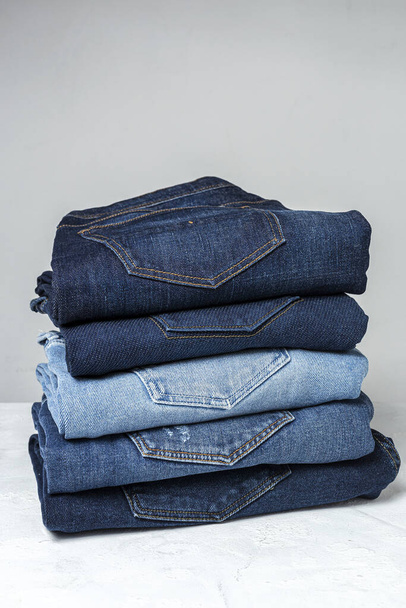 Blue jeans pants clothes pile background. Detail of nice blue jeans - Фото, изображение
