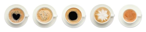 Set with cups of tasty aromatic coffee on white background, top view. Banner design - Fotografie, Obrázek