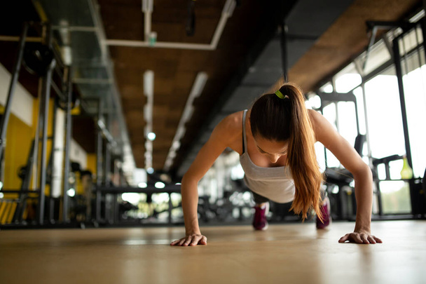 Attractive young fit woman exercising in gym. Sport healthy lifestyle people concept - Valokuva, kuva