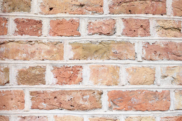 Orange house brick wall texture background with small details. Photo taken on a warm summer day in daylight. - 写真・画像
