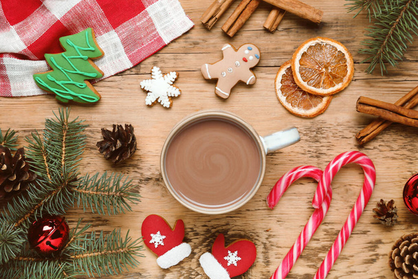 Flat lay composition with delicious hot chocolate and Christmas decor on wooden table - 写真・画像