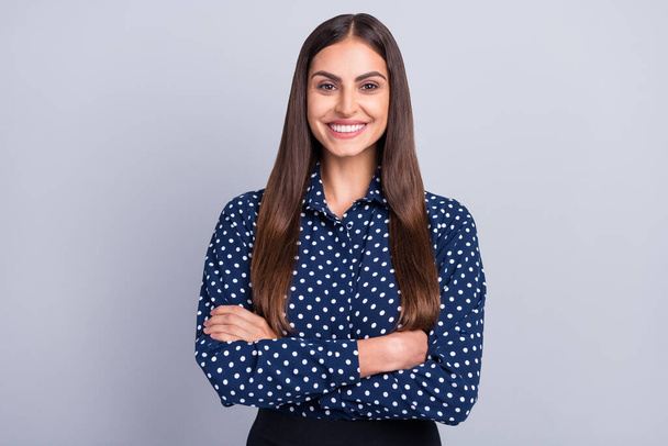 Photo of self-assured pretty business lady crossed arms shiny smile wear dotted blouse isolated grey color background - Foto, immagini