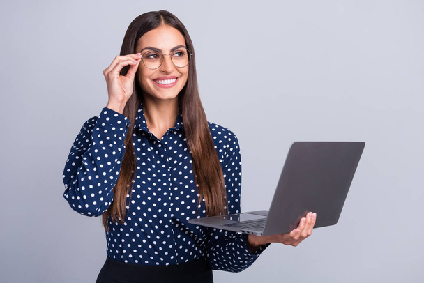 Photo of bossy millennial brunette lady hold laptop look wear blue shirt eyewear isolated on grey color background - Valokuva, kuva