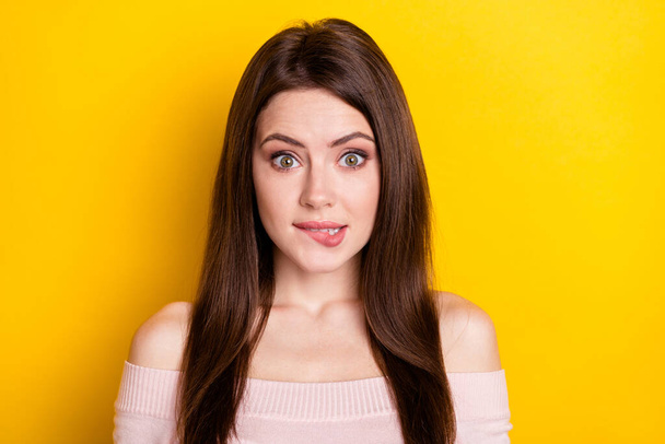Photo of optimistic brunette lady bite lips wear pink shirt isolated on yellow color background - Φωτογραφία, εικόνα