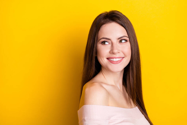 Photo of optimistic brunette lady look empty space wear pink shirt isolated on yellow color background - Fotoğraf, Görsel