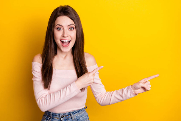 Photo of happy excited crazy amazed funky girl point fingers copyspace advertising product isolated on yellow color background - Foto, Imagen