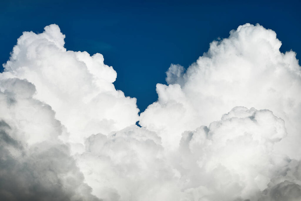 Epic storm cloudscape. White ornamental sunset cumulus clouds. Soft sunlight, sun rays. Clear blue sky. Natural pattern, texture, background, wallpaper, 3D, graphic resources, design, copy space - Photo, Image