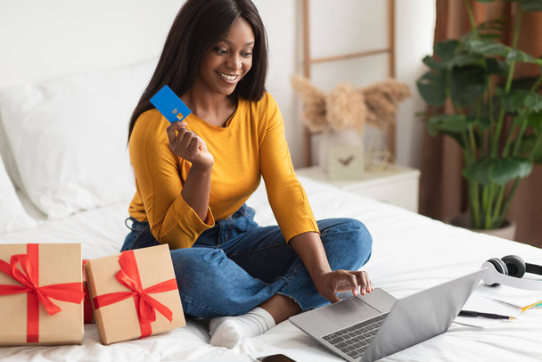African Female Shopping Gifts With Credit Card And Laptop Indoors - Photo, Image