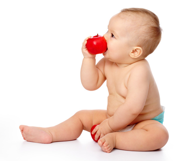 Little child with apple - Foto, afbeelding