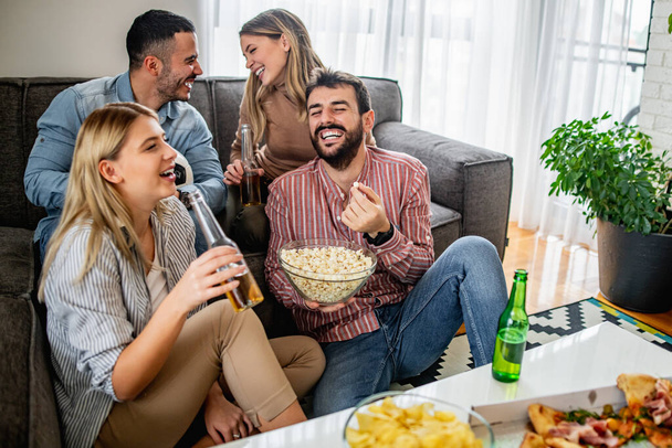 Cheerful group of friends watching football game on tv. Friendship, people and lifestyle concept. - Photo, Image