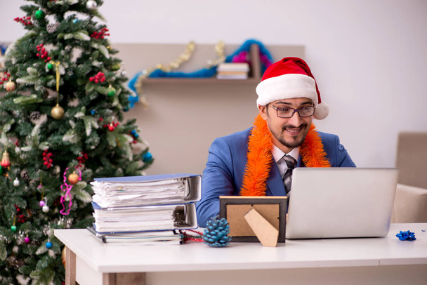 Young businessman working from home at Christmas eve - Photo, Image