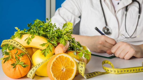 fresh healthy fruits with measuring tape dietician s desk. High quality photo - Foto, imagen