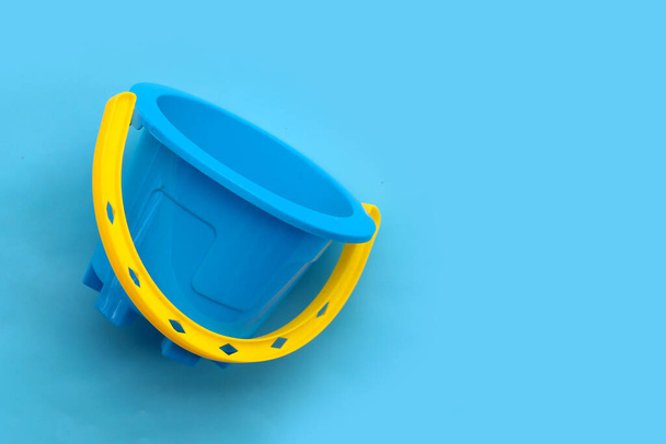 Plastic toy, Bucket on blue surface.  - Photo, Image