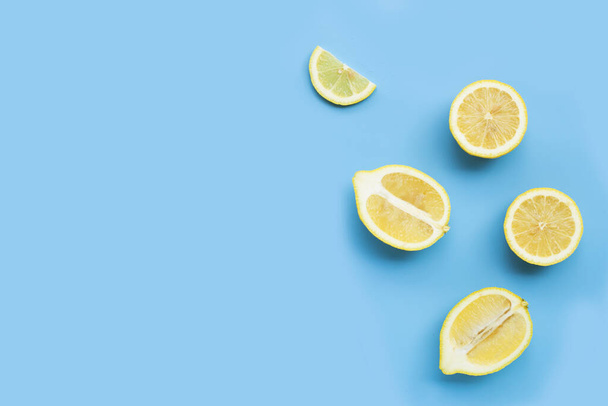 Fresh lemon slices on blue background. - Photo, Image