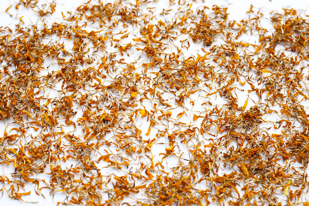 Dried marigold flower petals on white background. Flower herbal tea concept. - Photo, Image