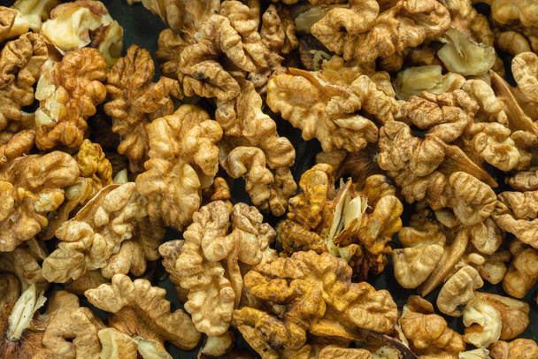 Top view of the halves of peeled walnuts. Close-up. Background image - Foto, Imagen