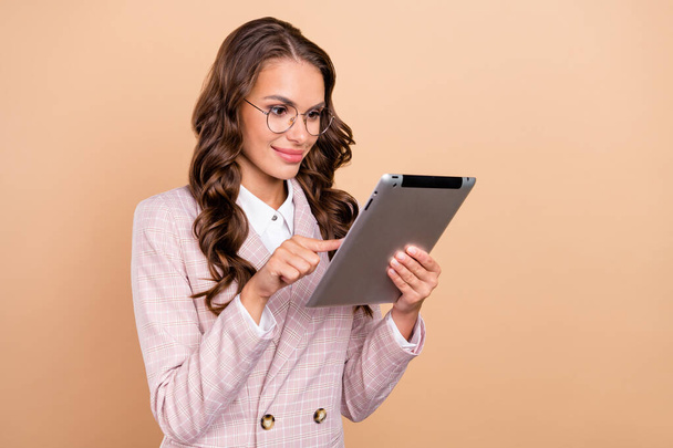 Photo of satisfied pretty lady hold use tablet have good mood coworking networking isolated on beige color background - Fotografie, Obrázek