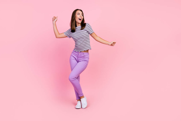 Photo of cute charming young woman dressed striped clothes dancing smiling isolated pink color background - Valokuva, kuva
