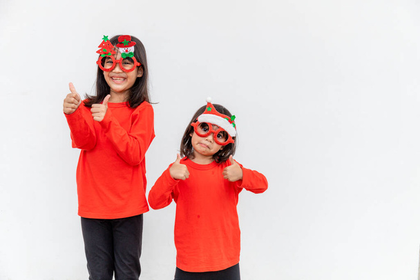Merry Christmas. Children cheerful celebrate Christmas.  Siblings are ready to celebrate Christmas or meet new year. - Photo, Image