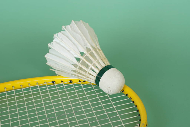shuttlecock with racket on the green background - Photo, Image