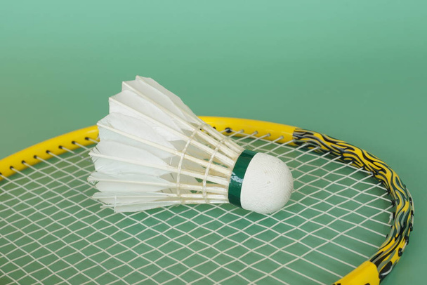 shuttlecock with racket on the green background - Photo, Image