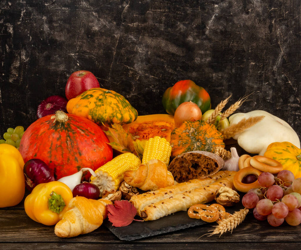 Autumn composition, Thanksgiving or Halloween concept, still life with fruits, pumpkin, vegetables, bountiful harvest, gifts of autumn. Flat lay, top view. High quality photo - Photo, Image