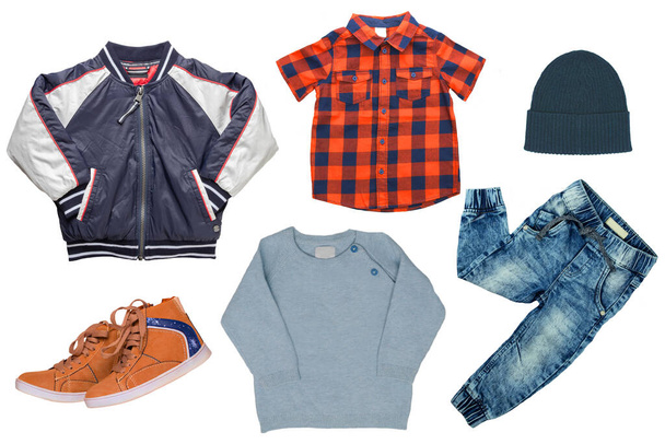 Collage set of little boy autumn clothing isolated on a white background. Denim trouser, a pair shoes, a rain jacket, pullover, a hood,  a shirt  and a sweater for child boy. Kids autum and winter fashion. - Foto, imagen