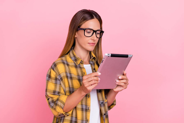 Photo of calm confident person hands hold tablet wear checkered isolated on bright pink color background - 写真・画像