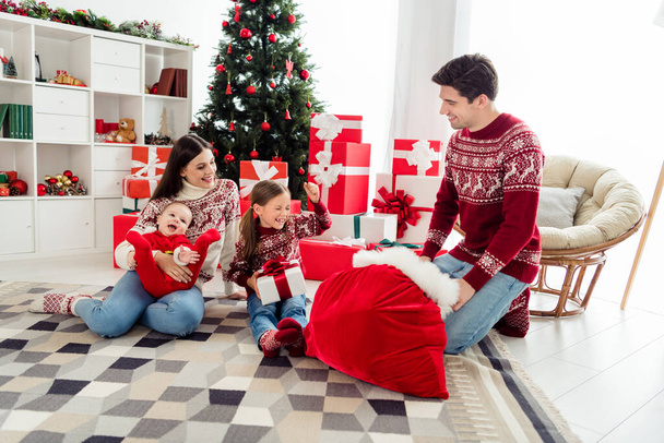 Photo of cute funny husband wife two children wear christmas sweaters sitting under tree waiting presents smiling indoors room home house - Photo, image