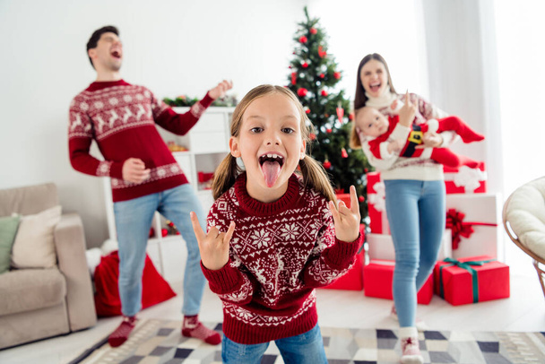 Photo of young cheerful family happy positive smile have fun little girl show fingers heart symbol eve time indoors - 写真・画像