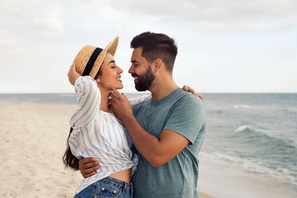 Lovely couple spending time together on beach - Фото, зображення
