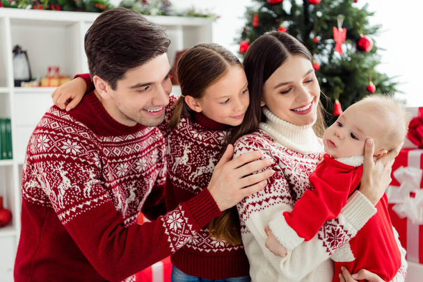 Photo of caring nice glad family embrace small baby child wear sweater in decorated x-mas home indoors - Valokuva, kuva
