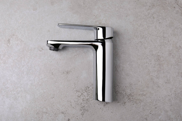 Single handle water tap on grey table, top view - Fotoğraf, Görsel