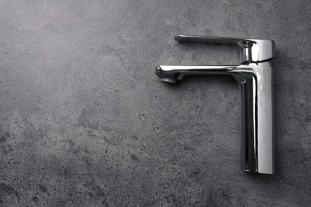 Single handle water tap on grey table, top view. Space for text - 写真・画像
