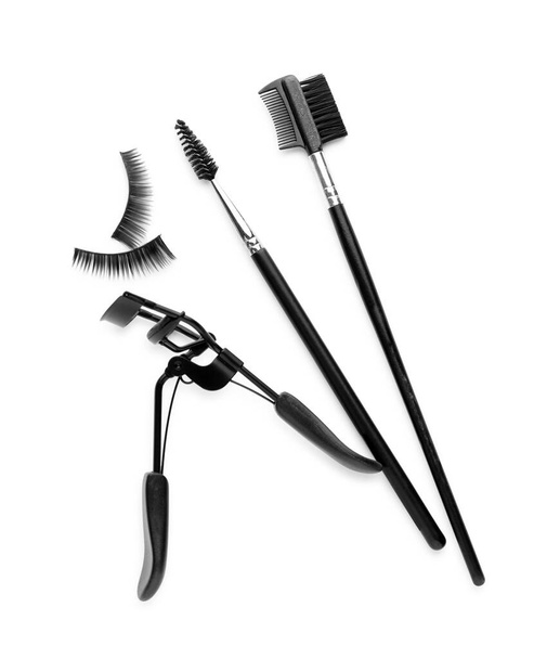 False eyelashes, curler and brushes on white background, top view - Φωτογραφία, εικόνα
