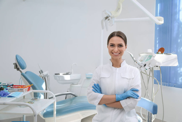 Portrait of professional dentist at workplace in clinic - Фото, изображение