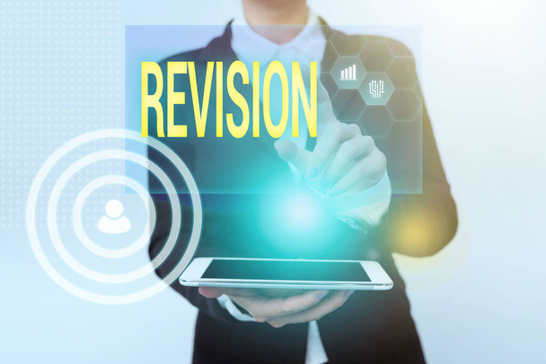 Sign displaying Revision. Business idea action of revising over someone like auditing or accounting Woman In Uniform Holding Mobile Phone Showing Futuristic Virtual Icons - Photo, Image