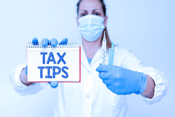Handwriting text Tax Tips. Business concept compulsory contribution to state revenue levied by government Testing New Vaccine For The Virus Presenting Vaccination Clinical Trials - Photo, Image