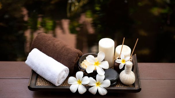 Lázeňská krása masáž zdravé wellness zázemí. Lázeňská thajská terapie aromaterapie pro tělo ženy s květinou Plumeria přírodní svíčka pro relaxaci letní čas. Životní styl a kosmetická koncepce - Fotografie, Obrázek