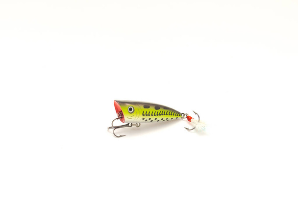 Single surface popper lure with multiple hoooks isolated on white background. Topwater fishing bait with cupped face carved - Photo, Image