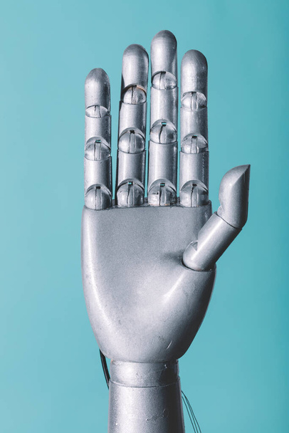 Mão robótica em retro estilo futuro no fundo azul - Foto, Imagem