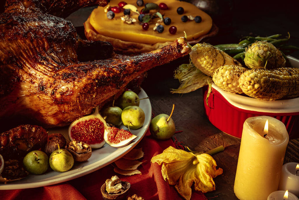 Close-up holiday decorated table with roasted turkey and season traditional vegetables. Thanksgiving day, national traditions - Φωτογραφία, εικόνα