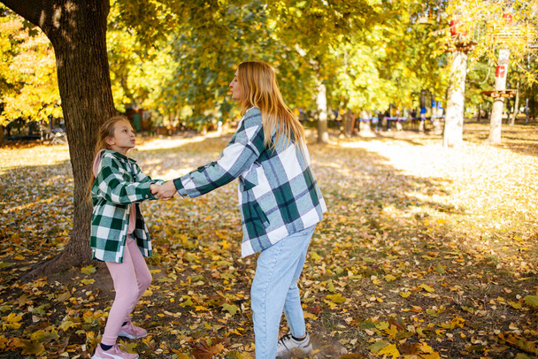 mother and daughter quarreling in park. Mother criticizing her disobedient child for bad behavior. Children upbringing. - Photo, image