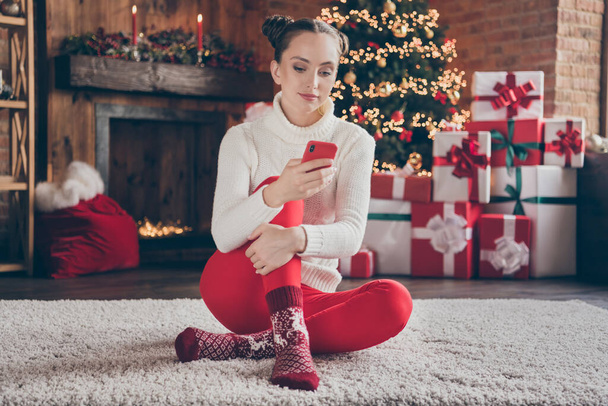 Full length photo of young girl browse cellphone blogger post comment wish happy new year atmosphere magic decor indoors - Photo, Image