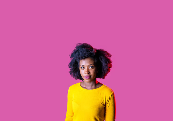 Estudio retrato joven negro mujer buscando cámara sonriendo positiva y contemplativa soñando despierto aislado publicidad copyspasce fondo - Foto, imagen