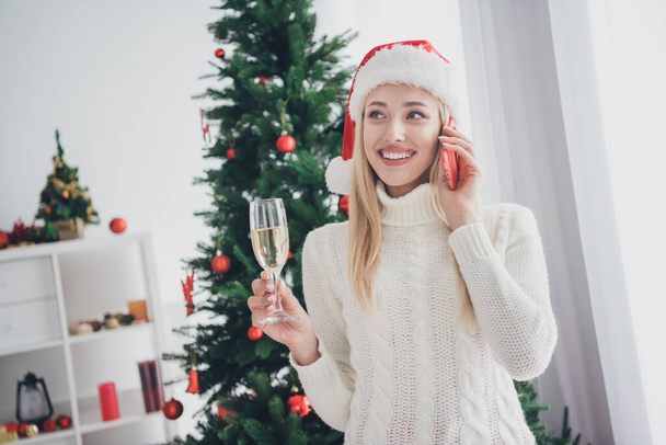 Photo of pretty dreamy nice happy young woman good mood hold hand phone talk champagne indoors inside house home - Fotografie, Obrázek