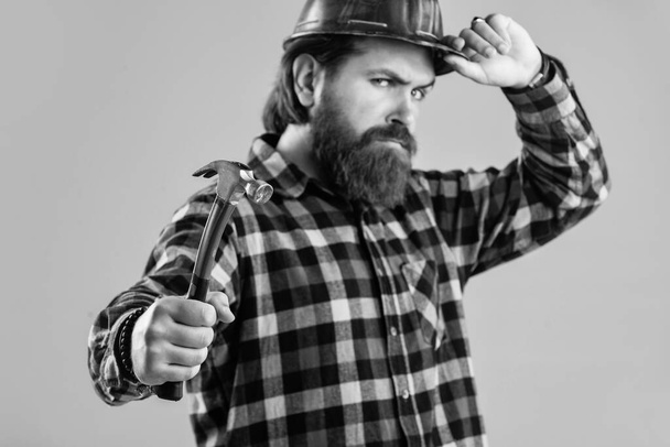 brutal bearded man worker in helmet. mature guy builder with beard and mustache - Photo, image