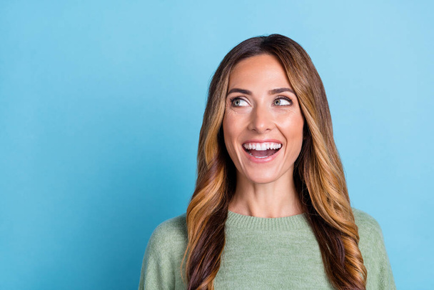 Photo portrait woman wearing green sweater laughing looking empty space isolated pastel blue color background - Foto, immagini
